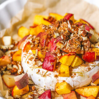 close up of peach pecan baked brie