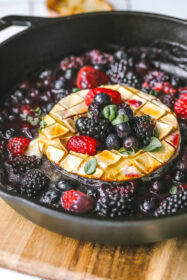 side angle brie in a pan topped with berries