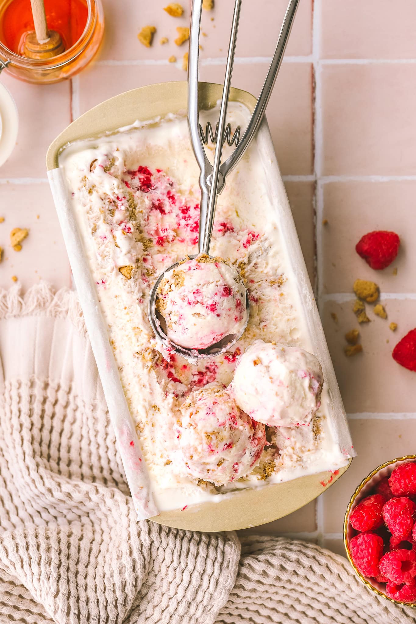 scoops of raspberry ice cream in a loaf pan