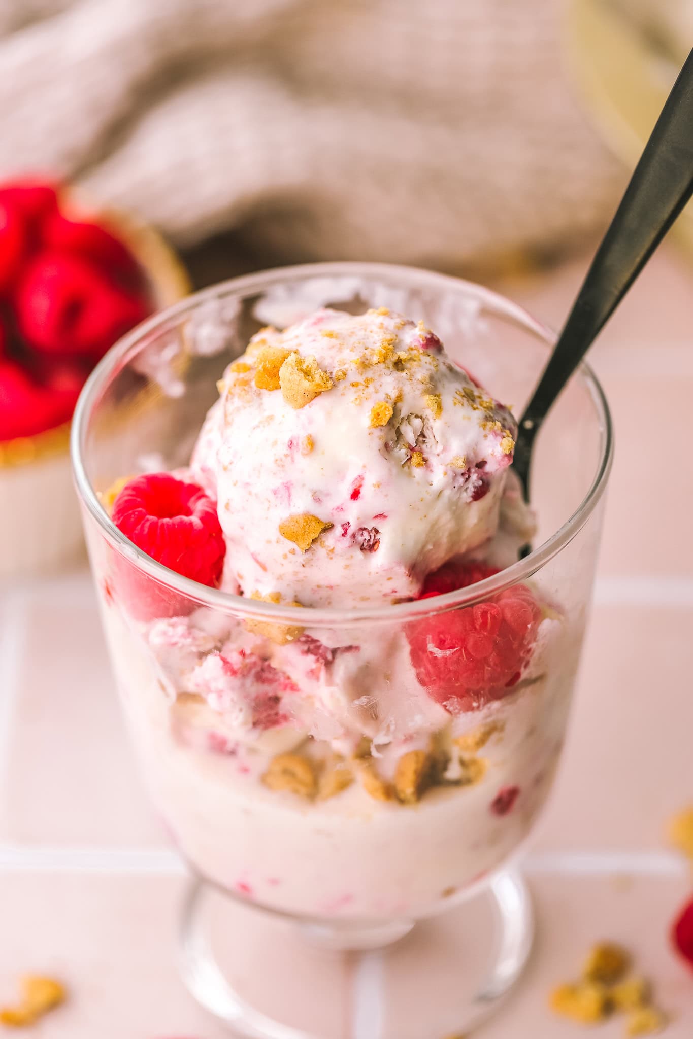 raspberry crumble ice cream in a cup with a spoon