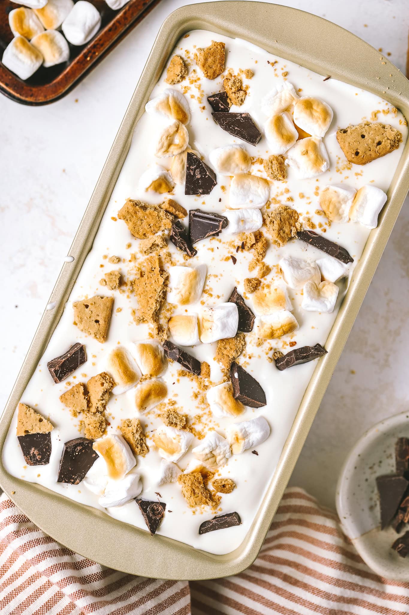 graham crackers, chocolate and marshmallows in ice cream mixture