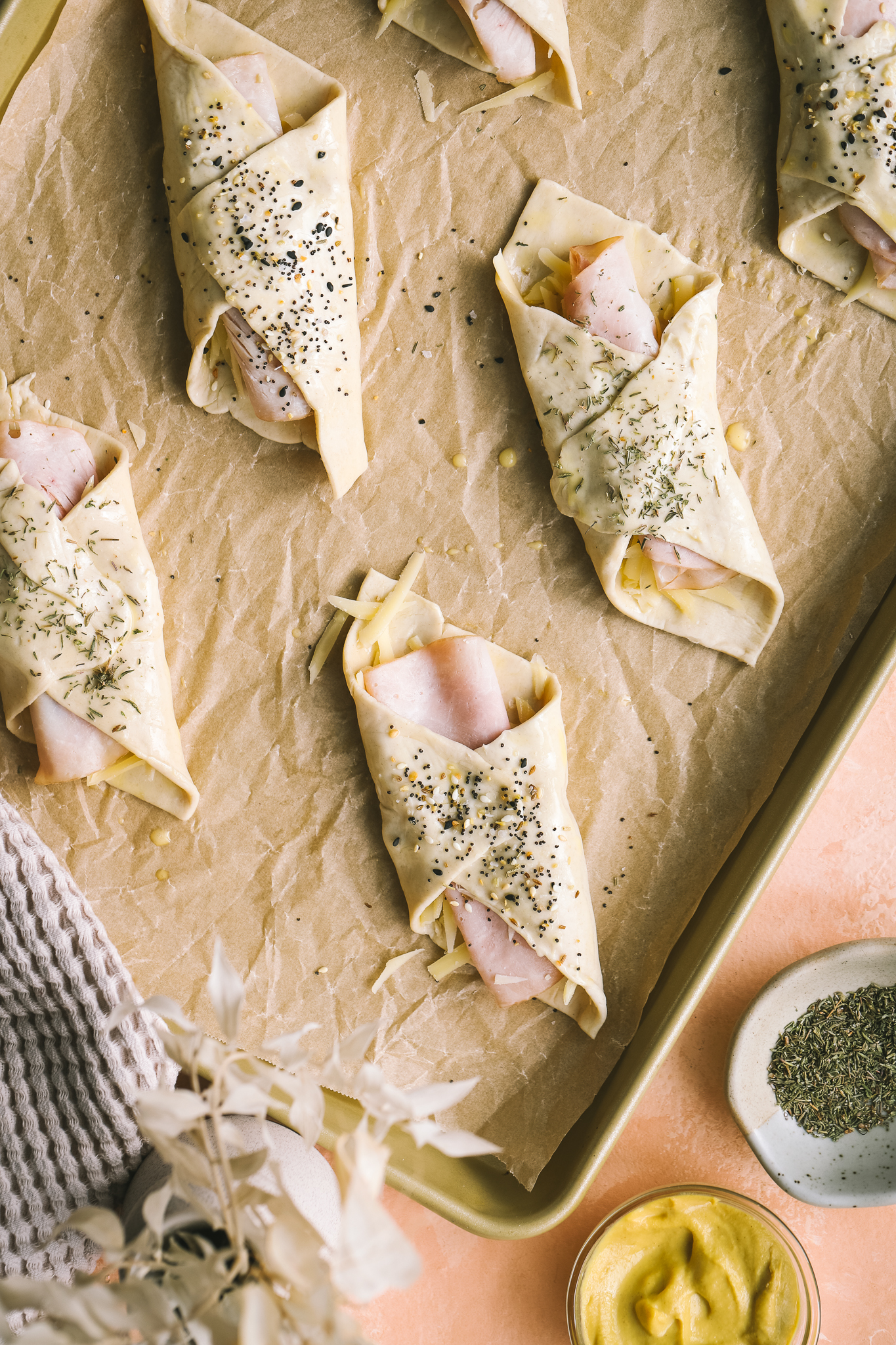 ham and cheese puff pastry bundles on a baking sheet