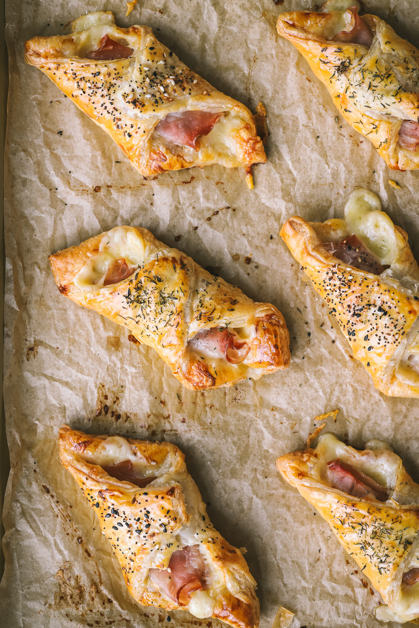 baking sheet with 6 baked puff pastry bundles